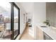 Contemporary hallway featuring a wet bar, sitting area, and sliding glass doors at 2391 King St, Denver, CO 80211