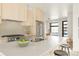Bright, modern kitchen featuring stainless steel appliances, a large island, and bar stool seating at 2391 King St, Denver, CO 80211