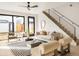 Bright living room features modern furniture, a ceiling fan, and stairs leading to the second floor at 2391 King St, Denver, CO 80211