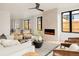Open-concept living room with modern fireplace, large windows, and inviting neutral-toned furniture at 2391 King St, Denver, CO 80211