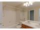 Traditional bathroom with double sink vanity, tiled shower-tub, and bright lighting at 6776 S Holland Way, Littleton, CO 80128
