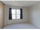 Cozy bedroom with plush carpeting and a large window offering natural light at 6776 S Holland Way, Littleton, CO 80128