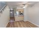 Open living area with hardwood floors, ceiling fan, and view of the kitchen at 6776 S Holland Way, Littleton, CO 80128
