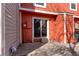 Small outdoor patio with sliding glass doors and orange wood paneling at 6776 S Holland Way, Littleton, CO 80128