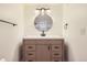 Bathroom vanity with a round mirror, modern lighting, and a neutral color scheme at 4691 S Decatur St # 215, Englewood, CO 80110
