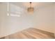 Cozy dining room with light hardwood floors and a modern light fixture, freshly painted and ready to be occupied at 4691 S Decatur St # 215, Englewood, CO 80110