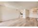 Spacious living room with light hardwood floors and a kitchen view, freshly painted and ready to be occupied at 4691 S Decatur St # 215, Englewood, CO 80110