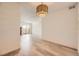Open-concept living space with light-colored floors and natural light from the balcony at 4691 S Decatur St # 215, Englewood, CO 80110