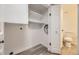 Hallway storage with a toilet and open shelving, providing convenient organization at 4691 S Decatur St # 215, Englewood, CO 80110