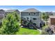 View of the home's backyard, including a green lawn, a two-level deck, a patio, and a staircase to the yard at 5528 Echo Hollow St, Castle Rock, CO 80104