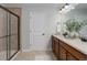 Bathroom includes double sinks, wood cabinets, tile floors and a glass enclosed shower at 5528 Echo Hollow St, Castle Rock, CO 80104