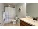 Well-lit bathroom with vanity, tile floor, and shower with a decorative curtain at 5528 Echo Hollow St, Castle Rock, CO 80104