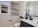 Stylish powder room featuring a modern vanity, elegant mirror, and artistic wall decor at 5528 Echo Hollow St, Castle Rock, CO 80104