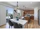 Stylish dining area with modern lighting, a view of the kitchen, and access to the backyard patio at 5528 Echo Hollow St, Castle Rock, CO 80104