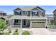 Exterior front elevation of a two-story home showcasing a covered porch, a two-car garage, and manicured landscaping at 5528 Echo Hollow St, Castle Rock, CO 80104