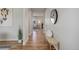 Hallway with wood floors leading to a living room with a gray couch at 5528 Echo Hollow St, Castle Rock, CO 80104