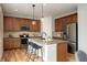 Charming kitchen with stainless steel appliances, granite countertops, kitchen island with seating, and hardwood floors at 5528 Echo Hollow St, Castle Rock, CO 80104