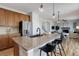 Modern kitchen featuring a spacious granite island with seating, stainless steel appliances, and wood cabinetry at 5528 Echo Hollow St, Castle Rock, CO 80104