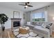 Cozy living room featuring a stone fireplace, plush seating, and a large window with scenic views at 5528 Echo Hollow St, Castle Rock, CO 80104