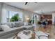 Open-concept living room with hardwood floors, and a view of the dining area and backyard at 5528 Echo Hollow St, Castle Rock, CO 80104