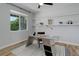 Bright office space features a modern desk, open shelving and lots of natural light from the window at 5528 Echo Hollow St, Castle Rock, CO 80104