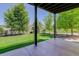 Covered patio with decorative concrete, supporting beams, and view of fenced and landscaped backyard at 5528 Echo Hollow St, Castle Rock, CO 80104
