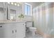 The bathroom offers natural light with white tile flooring and includes the shower and toilet at 1248 W 135Th Ave, Denver, CO 80234