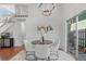 Dining area with round table, white chairs, and sliding glass doors with natural light at 1248 W 135Th Ave, Denver, CO 80234
