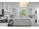 Bright kitchen with white cabinets, stainless steel appliances, and a large window at 1248 W 135Th Ave, Denver, CO 80234