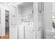 Practical laundry area, featuring a white washer and dryer, as well as built-in shelving units at 1248 W 135Th Ave, Denver, CO 80234