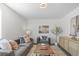 This living room has a large painting over the sofa and a vibrant tree next to the media console at 1248 W 135Th Ave, Denver, CO 80234