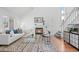 Bright living room features a fireplace, white sofa with patterned cushions, and wood floors at 1248 W 135Th Ave, Denver, CO 80234