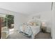 Bright main bedroom with a decorative metal bed frame and a sliding glass door to the outside at 1248 W 135Th Ave, Denver, CO 80234