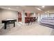 Finished basement with built-in bar, pool table, seating, and neutral-colored carpet at 8533 S Flower Ct, Littleton, CO 80128