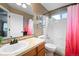 Traditional bathroom with vanity, single sink, and shower-tub combo with tile surround at 8533 S Flower Ct, Littleton, CO 80128