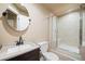 Neutral toned bathroom featuring vanity, toilet, and glass enclosed shower at 8533 S Flower Ct, Littleton, CO 80128