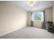 Bright bedroom features a large window and neutral-colored walls and carpet at 8533 S Flower Ct, Littleton, CO 80128