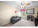 Comfortable bedroom featuring carpet, a grey sofa, and a bright pink curtain at 8533 S Flower Ct, Littleton, CO 80128