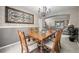 Formal dining room with a wooden table set, chandelier, and decorative wall art at 8533 S Flower Ct, Littleton, CO 80128