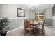Elegant dining room with hardwood table and chairs, wainscoting and modern lighting at 8533 S Flower Ct, Littleton, CO 80128