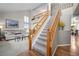 Bright foyer with a staircase, hardwood floors, and views into the living room at 8533 S Flower Ct, Littleton, CO 80128