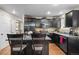 Elegant kitchen features dark cabinets, stainless appliances, and a breakfast bar at 8533 S Flower Ct, Littleton, CO 80128