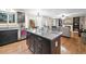 Modern kitchen with granite countertop island, stainless steel dishwasher, and hardwood floors at 8533 S Flower Ct, Littleton, CO 80128