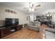 Spacious living room with hardwood floors, a ceiling fan, and easy access to the kitchen at 8533 S Flower Ct, Littleton, CO 80128