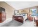 Spacious main bedroom features a large window, sleigh bed, and wood dresser at 8533 S Flower Ct, Littleton, CO 80128