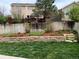 Spacious backyard featuring stone terracing, garden beds, a wooden fence, and a charming gazebo at 5126 S Malaya Way, Centennial, CO 80015