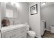 Modern half bathroom featuring a stylish vanity, framed art, and a convenient laundry area at 5126 S Malaya Way, Centennial, CO 80015