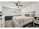 Comfortable bedroom with a ceiling fan, wainscoting, a soft bed, and natural light at 5126 S Malaya Way, Centennial, CO 80015