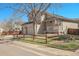 Well-maintained home with a three-car garage, manicured lawn, and inviting front porch at 5126 S Malaya Way, Centennial, CO 80015