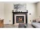 Close-up of a charming fireplace featuring a dark mantel and a decorative tree print at 5126 S Malaya Way, Centennial, CO 80015
